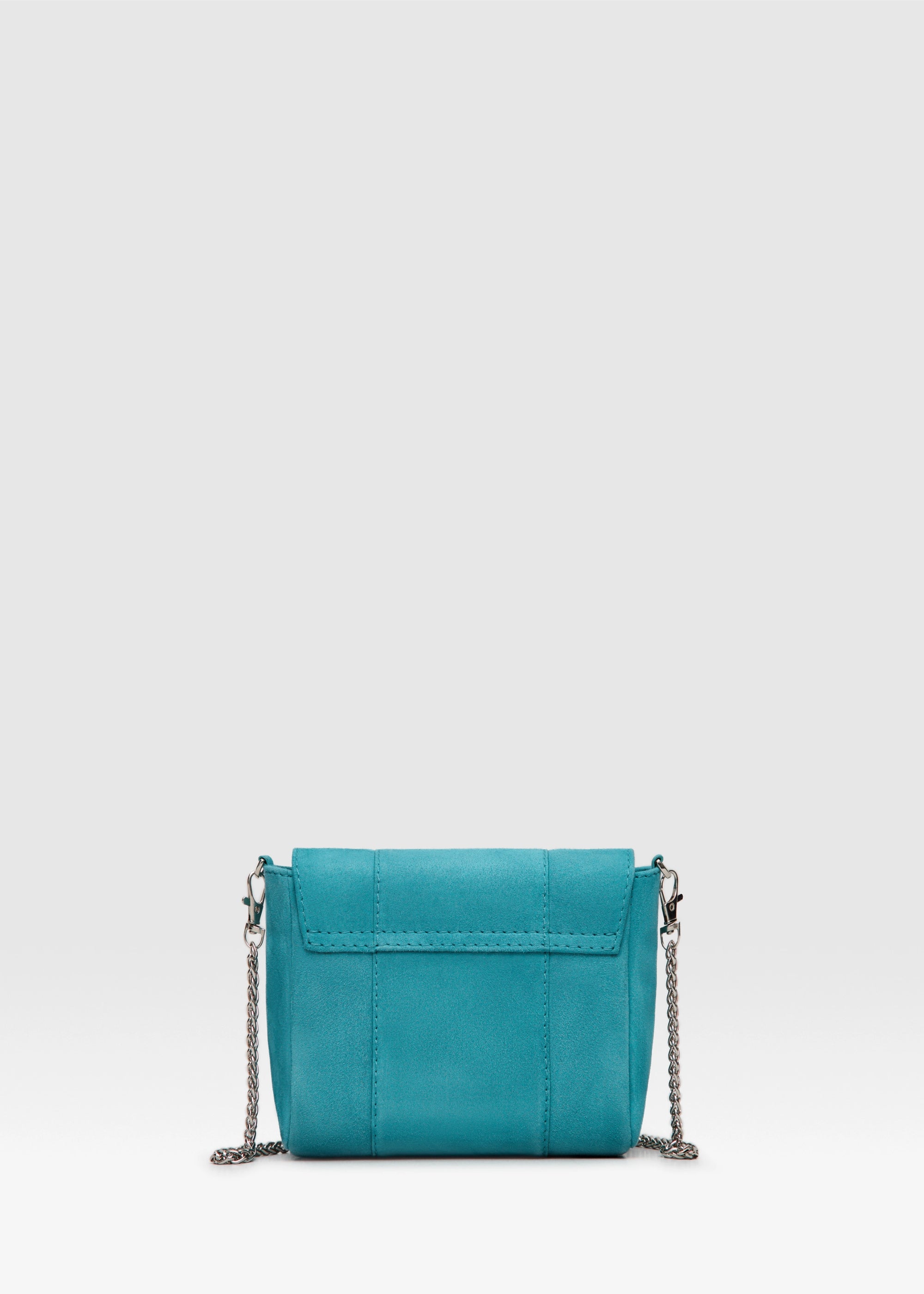 Back view of the Philini Marina Mini Crossbody Bag in turquoise suede leather, rectangular silhouette with front flap and silver chain shoulder strap. Handcrafted suede designer bag 
