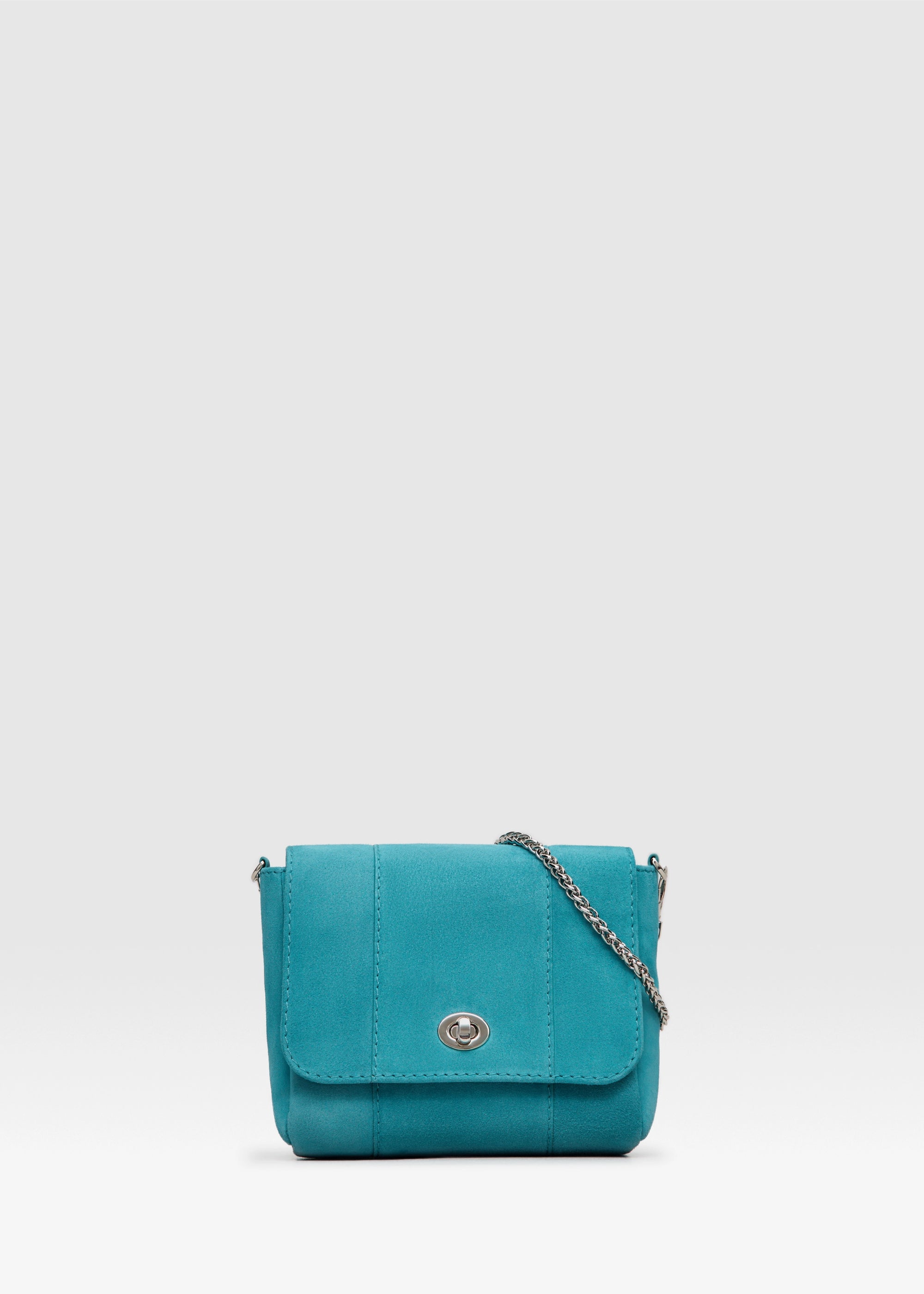 Front view of the Philini Marina Mini Crossbody Bag in turquoise suede leather, rectangular shape with front flap, silver clasp, and silver chain shoulder strap. Chic mini suede bag with a soft finish