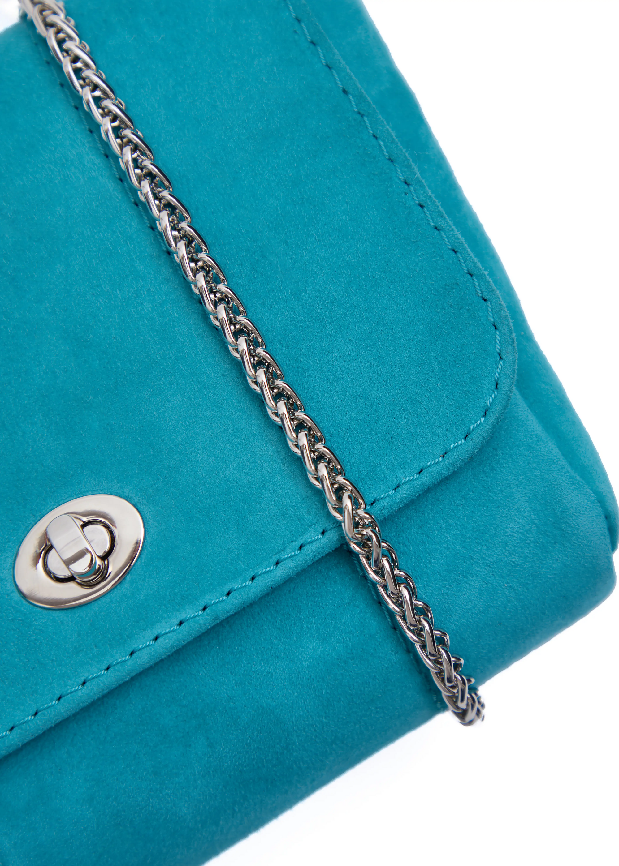 Close front view of the Philini Marina Mini Crossbody Bag in turquoise suede leather, showing front flap with silver clasp, silver chain. Stylish and functional suede mini bag for everyday wear.