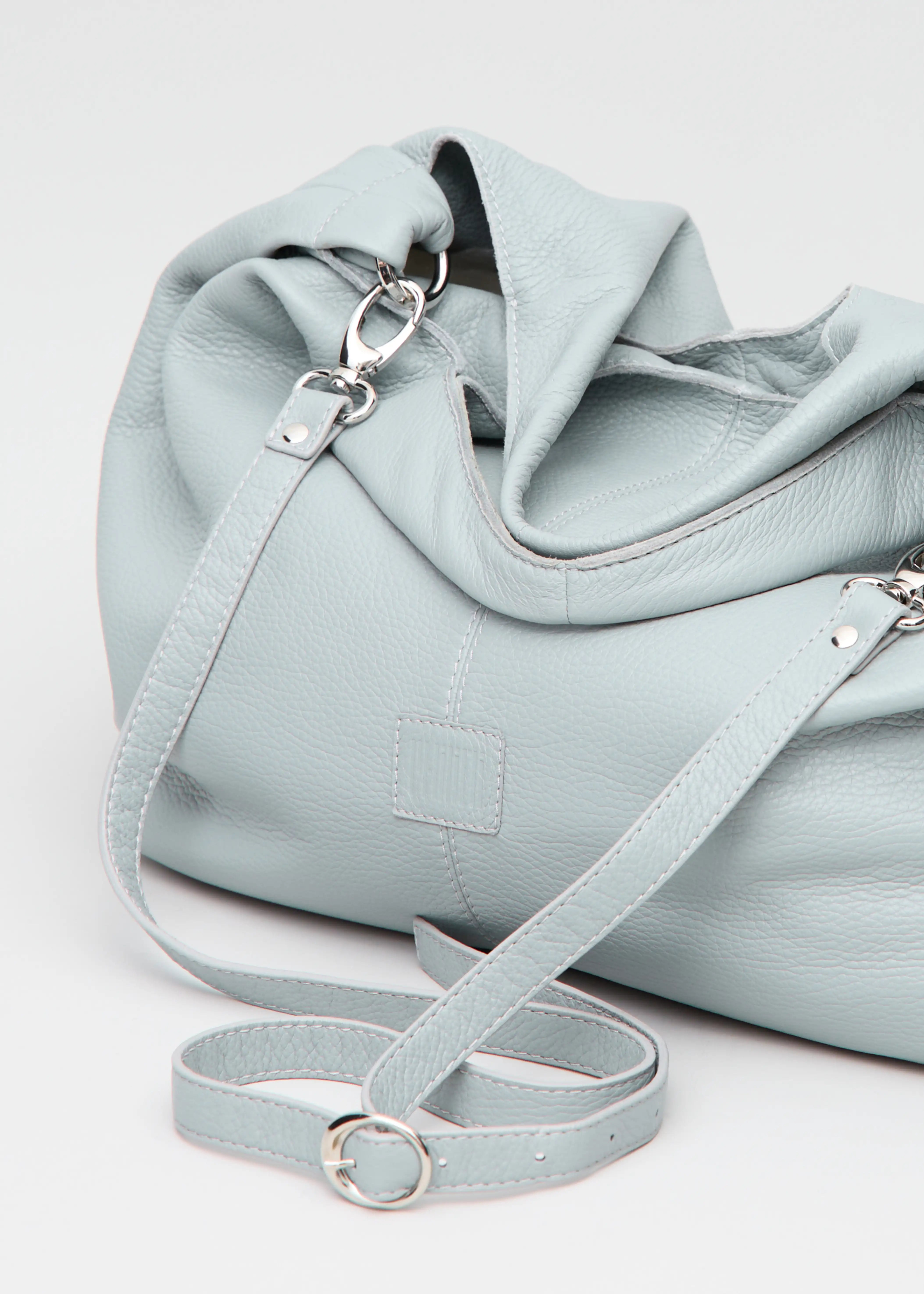 Philini Melanie Hobo Bag in grey buffalo leather, featuring two top handles, a detachable long strap with silver hardware, and a stamped logo. Luxury minimalist shoulder bag for women