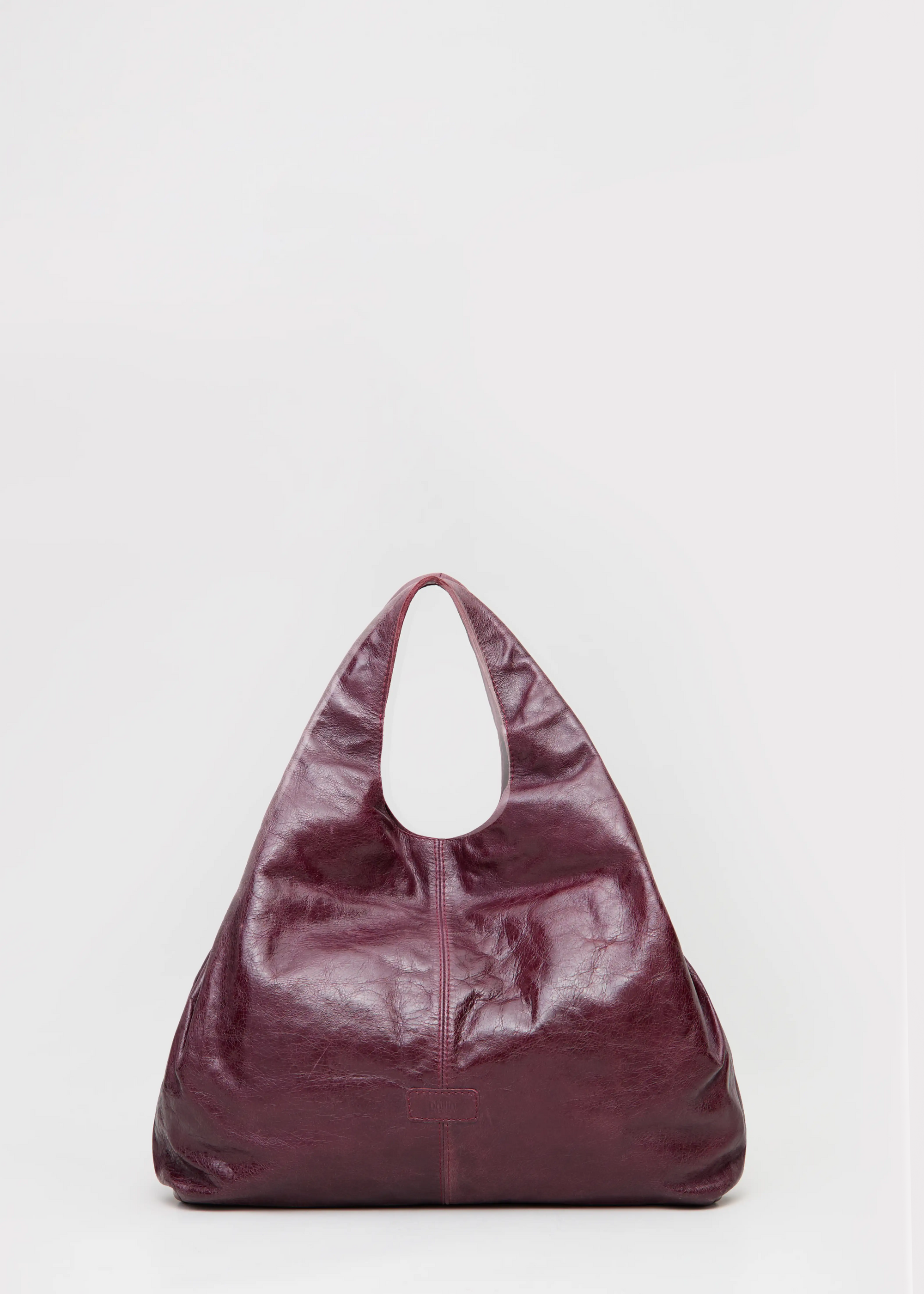 Front view of the Philini Melanie Hobo Bag in burgundy calf leather, featuring two top handles and a leather patch with stamped logo. Elegant leather hobo tote