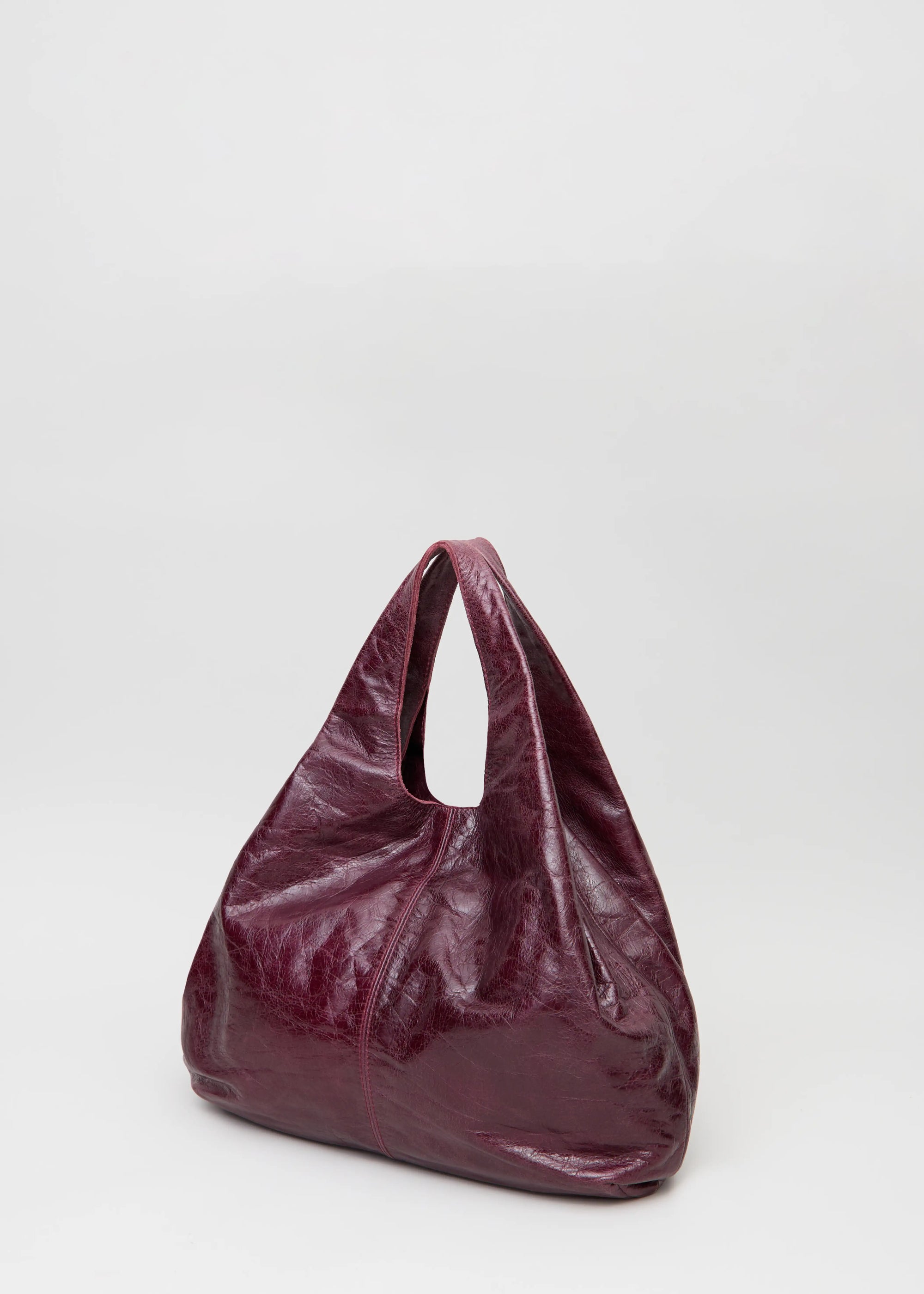 Back view of the Philini Melanie Hobo Bag in burgundy calf leather, featuring two top handles.  Premium minimalist shoulder bag for women