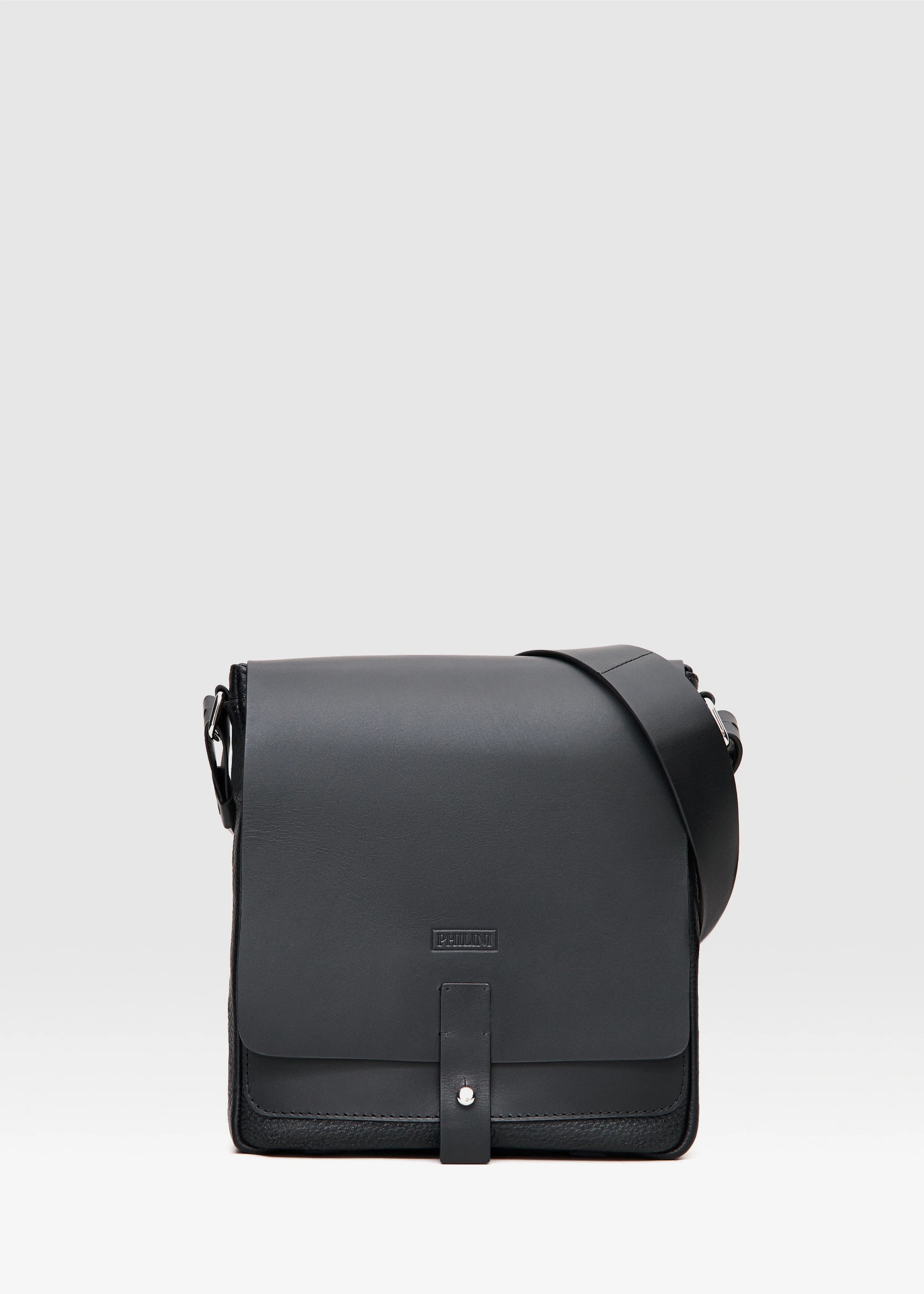 Black leather crossbody bag on a light gray background