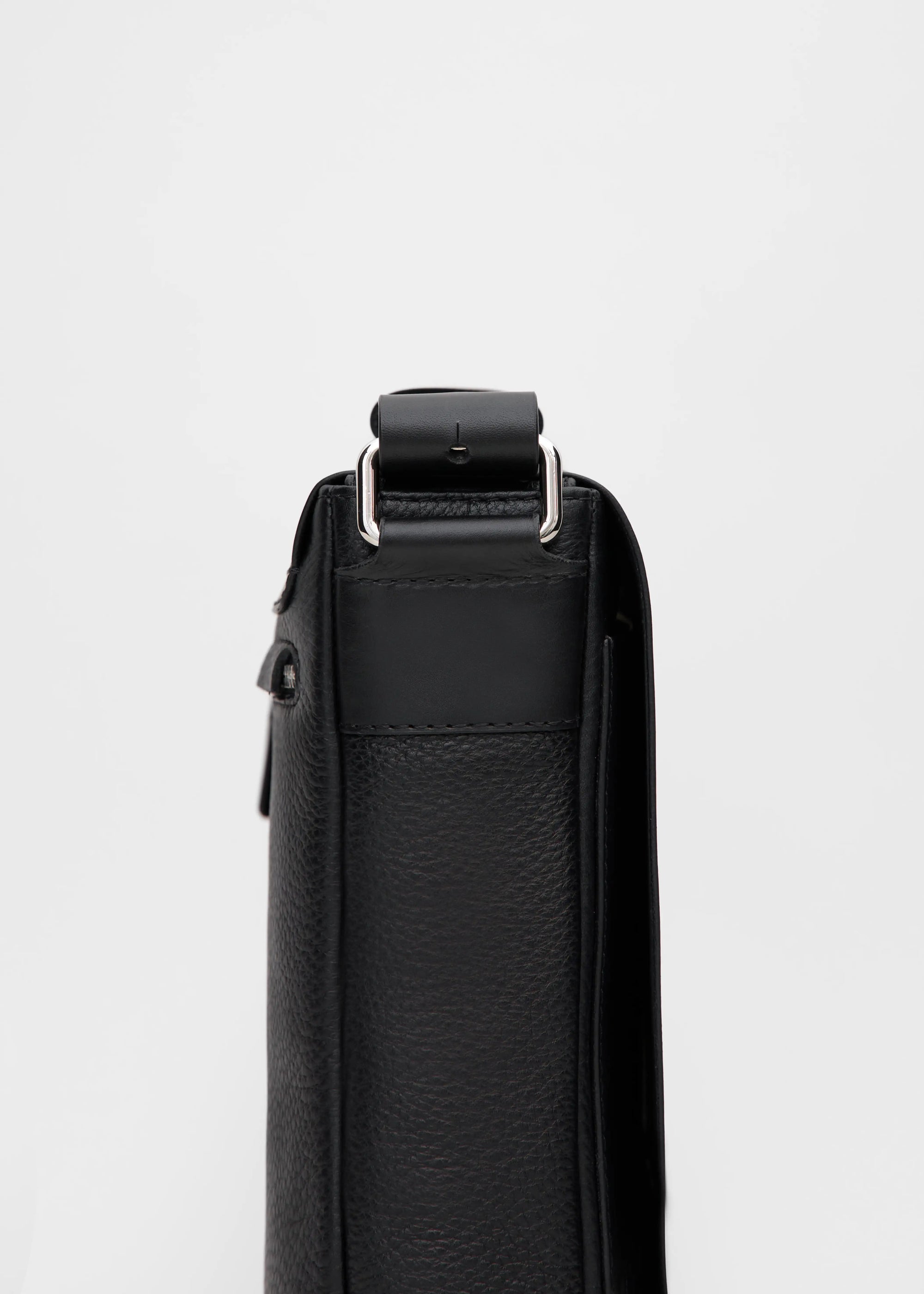 Close-up side view of the Philini Olga Black Leather Messenger Bag, highlighting silver-colored handle details and the rich texture of premium full-grain leather.
