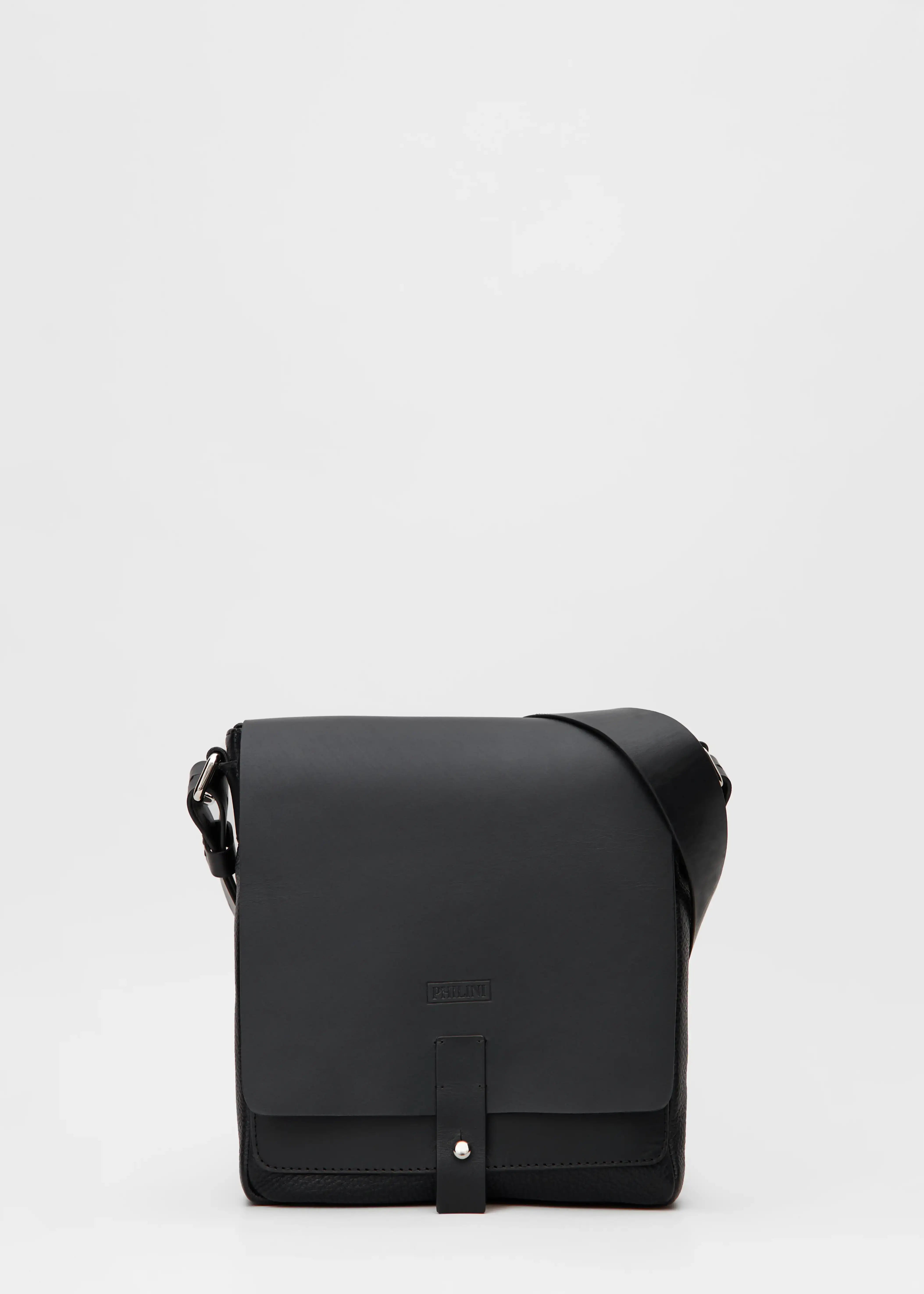 Front view of the Philini Olga Black Messenger Bag, crafted from premium full-grain leather in a slightly square shape with a front flap and silver cufflink closure. Features an adjustable leather strap and silver accents. A sustainable, handcrafted leather bag 