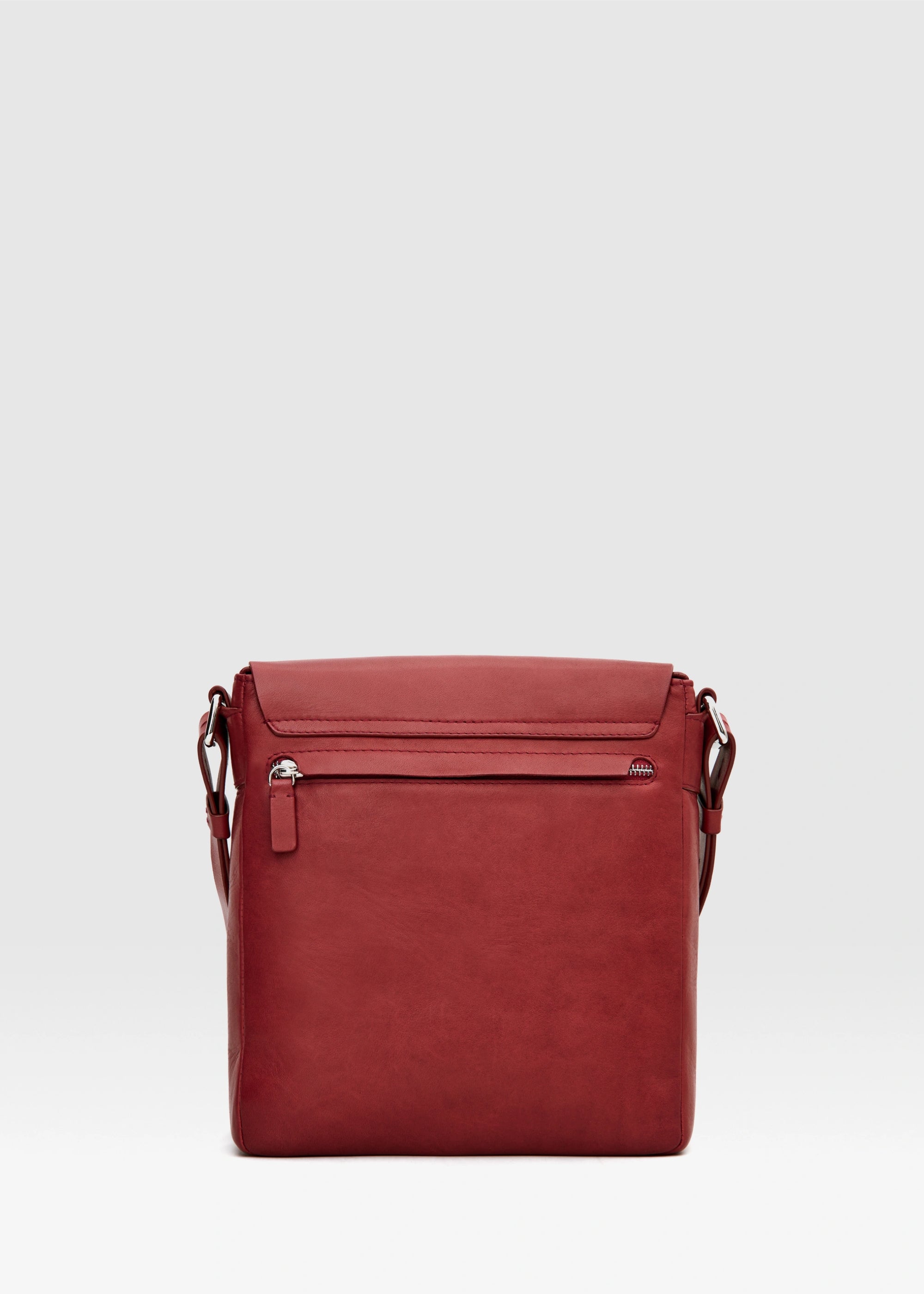 Back view of red aniline nappa leather Philini Olga Bag with rectangular shape, hidden back zip pocket, and adjustable strap. Handcrafted red leather shoulder bag for work and minimalist style