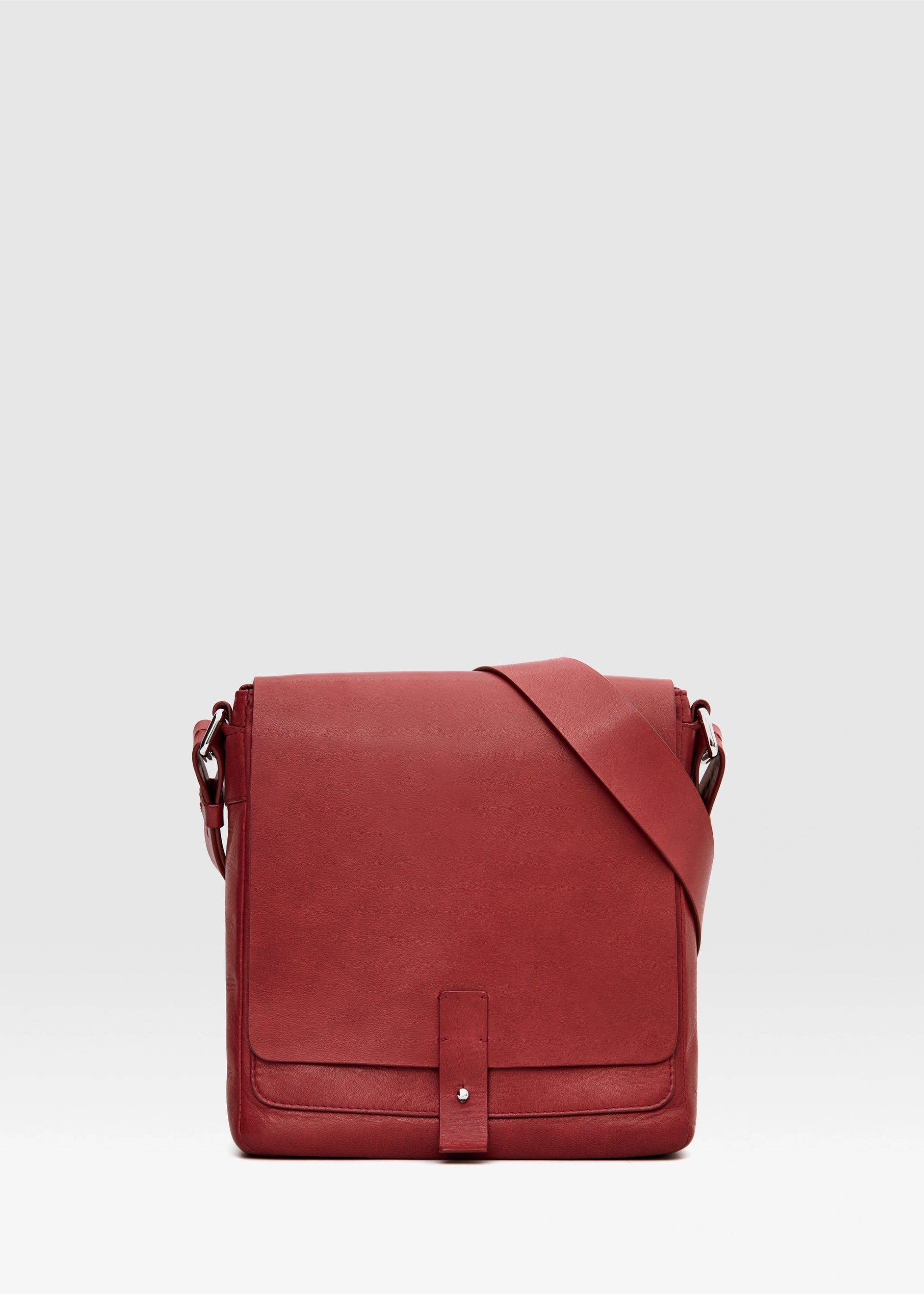 Front view of red aniline nappa leather Philini Olga Postman-style Bag with rectangular shape, silver cufflink closure, and adjustable strap. Elegant handcrafted leather handbag for everyday wear and sustainable fashion