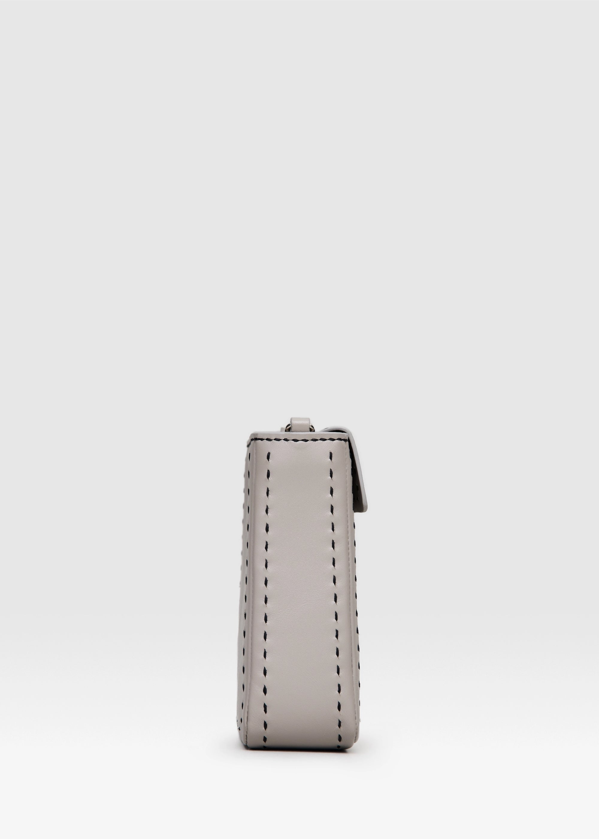 Profile view of the Philini Saphira Purse in taupe aniline leather, compact rectangular shape with hand-stitched details, sleek half-lap flap, and convertible chain and leather straps. Elegant handmade leather evening purse.
