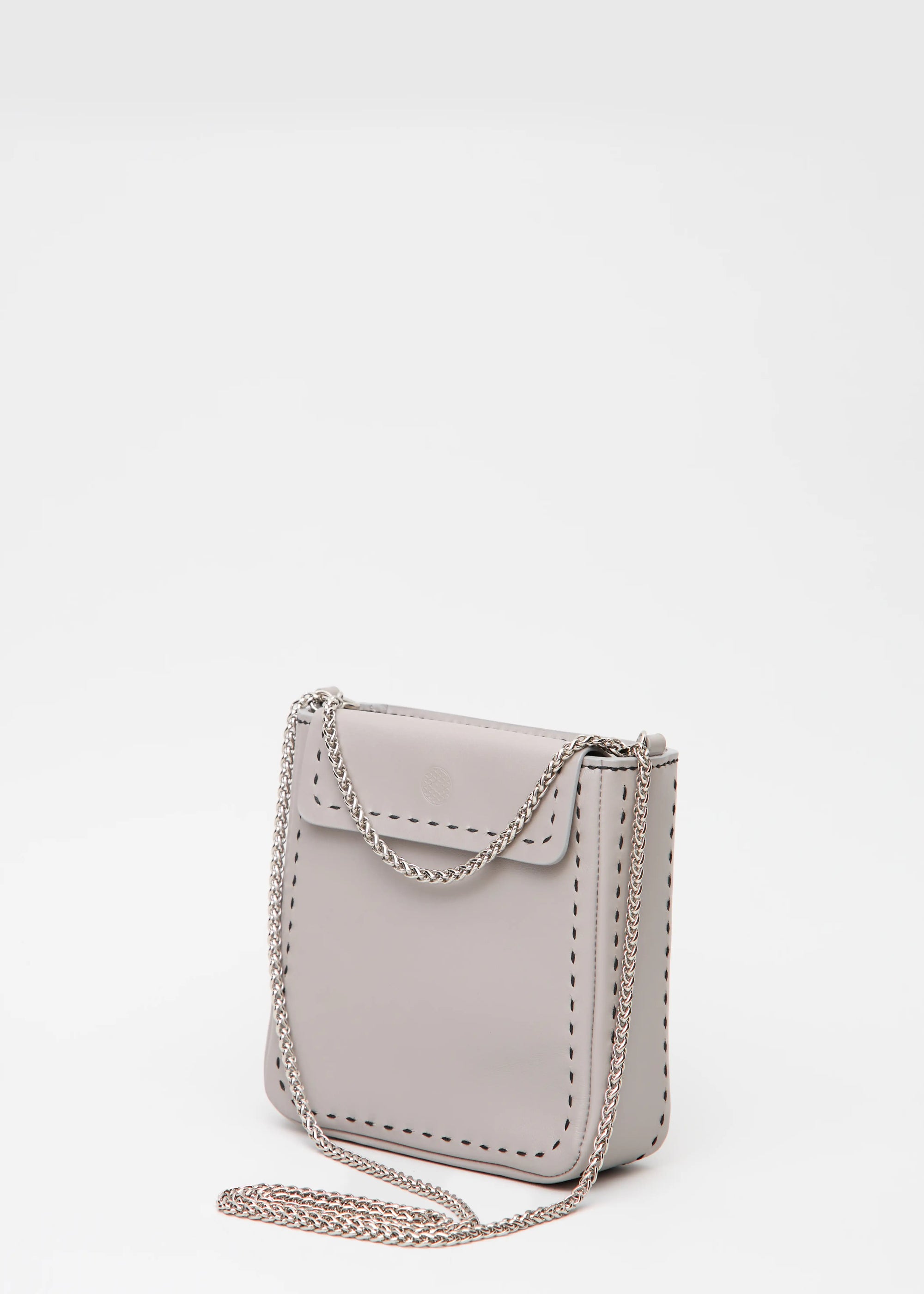 Side view of the Philini Saphira Purse in taupe aniline leather, compact rectangular shape with hand-stitched details, sleek half-lap flap, and convertible chain and leather straps. Elegant handmade leather evening purse.