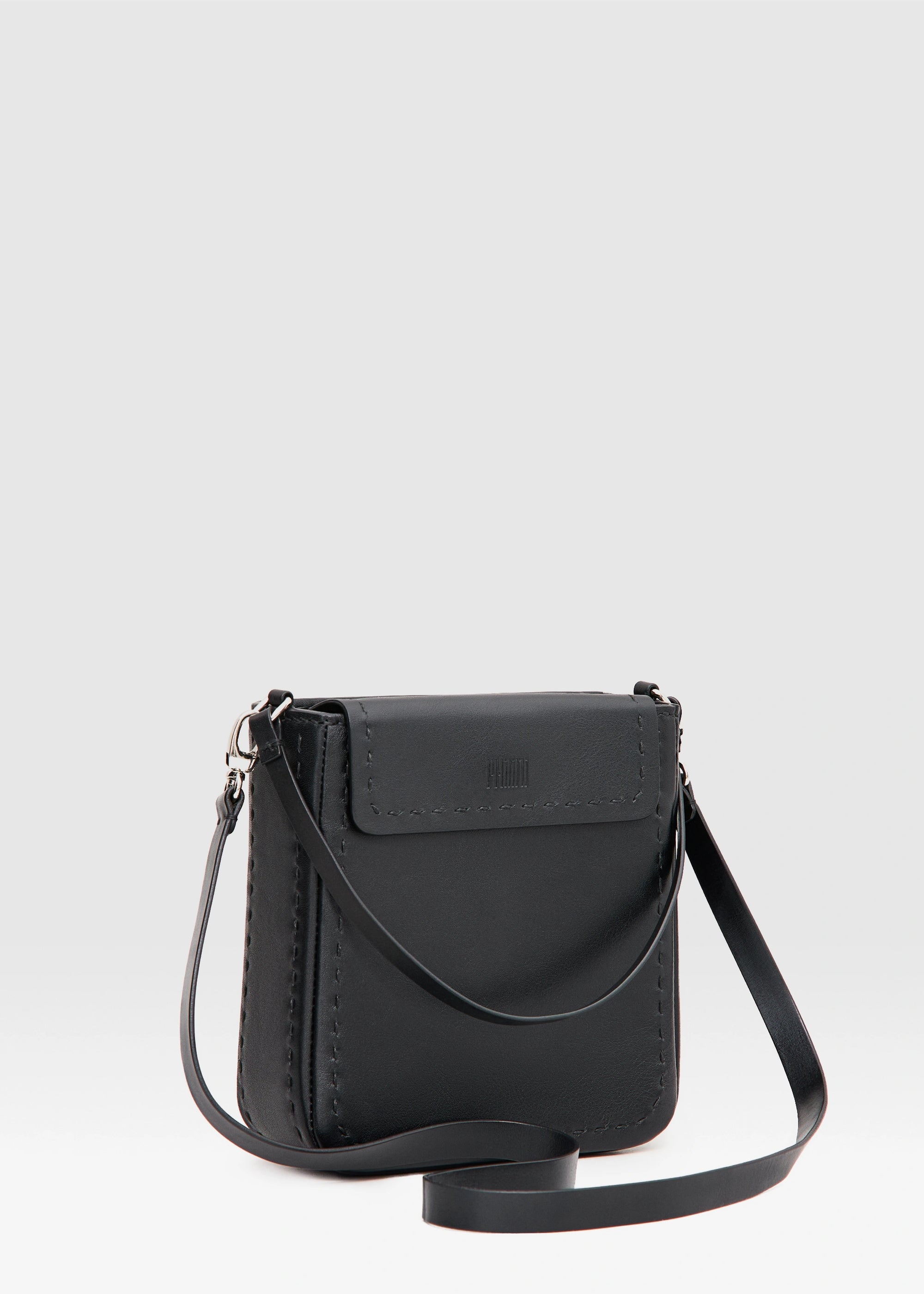 Side view of the Philini Saphira Purse in black aniline leather, compact rectangular silhouette with hand-stitched accents, smooth half-lap flap, and versatile leather and chain handles. Handmade black leather evening bag.