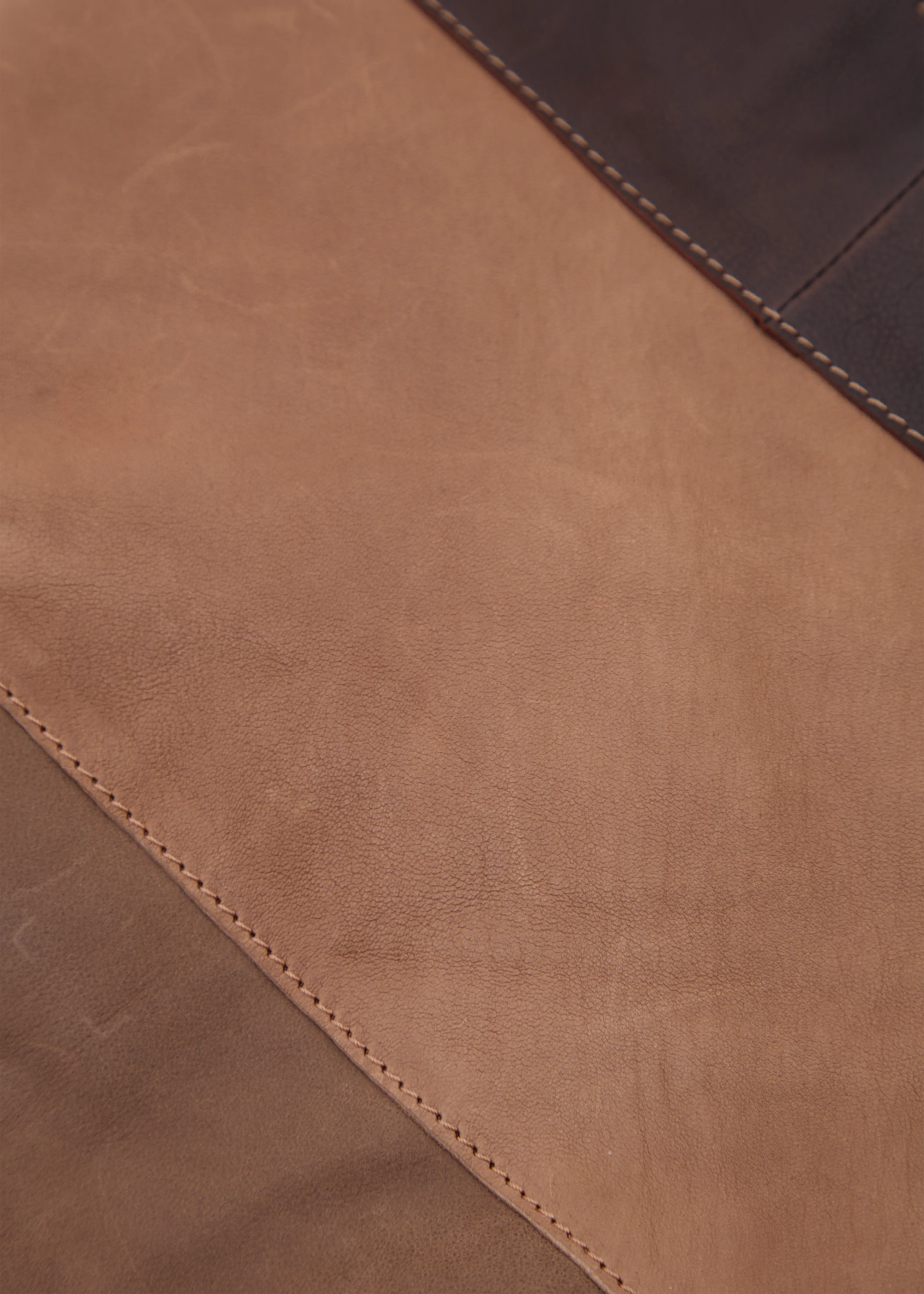 Close-up of the Philini Semfira Hobo Bag in soft brown nubuck and calf leather, focusing on the texture interplay, earth-toned straps, and detailed craftsmanship. Designed and luxury warm-toned suede-leather hobo