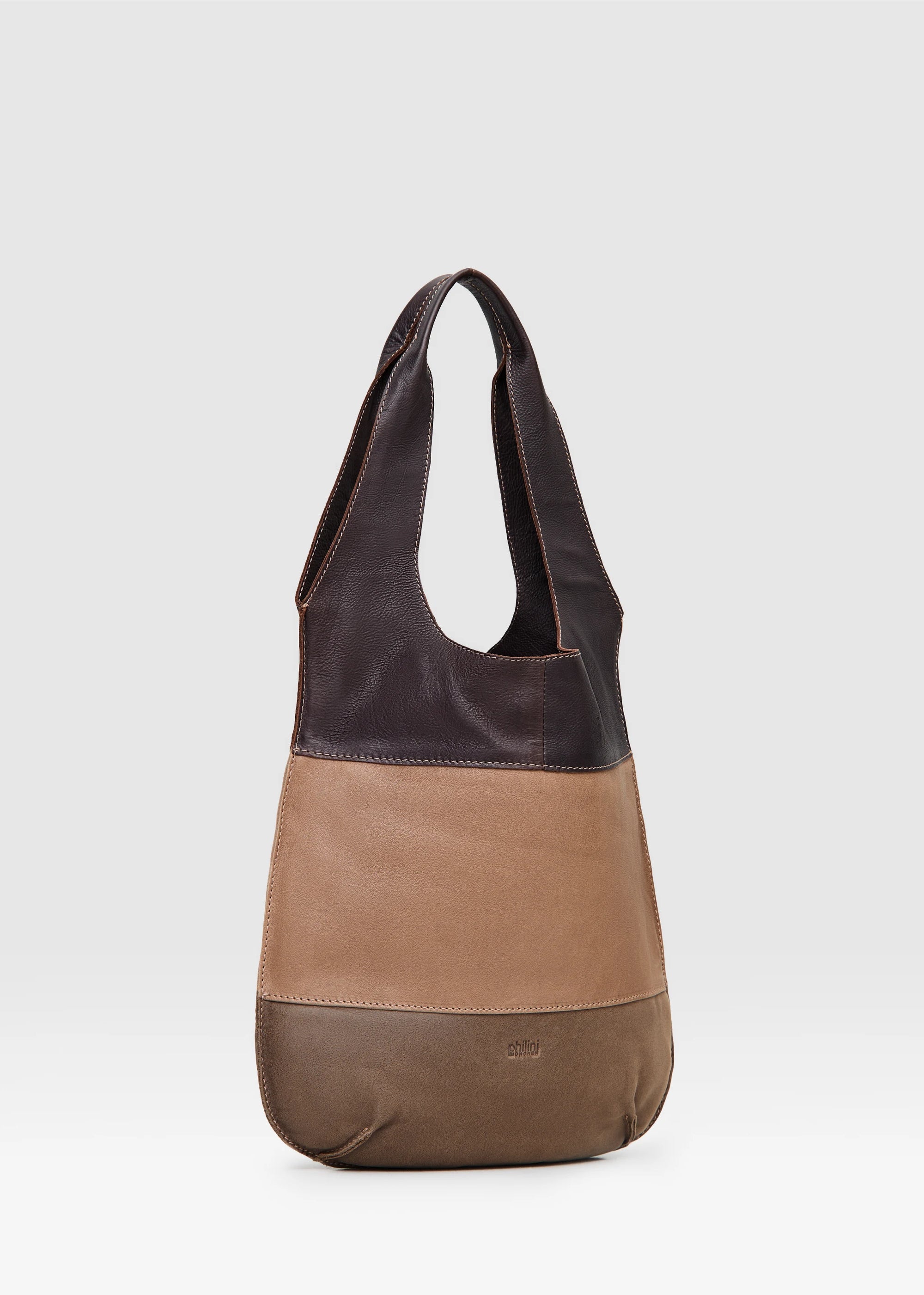 Side view of the Philini Semfira Hobo Bag in warm-toned nubuck and calf leather, two integrated handles, soft curved edges, and stamped logo. Earthy-toned designer handbag