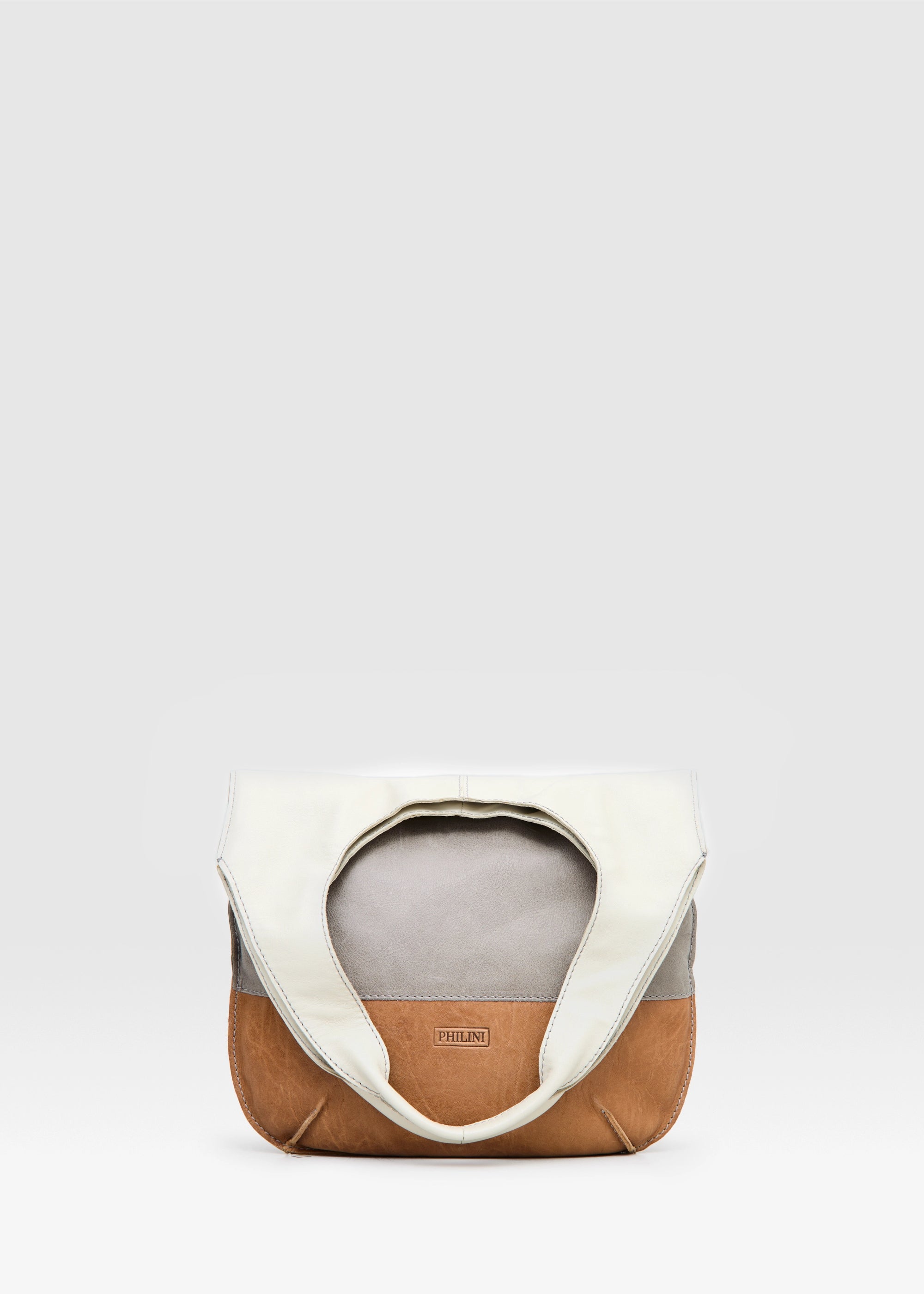 Folded view of the Philini Semfira Hobo Bag in cognac wild calf leather, highlighting multicolor gentle straps and hand-maded stitching. Sustainable designer leather hobo