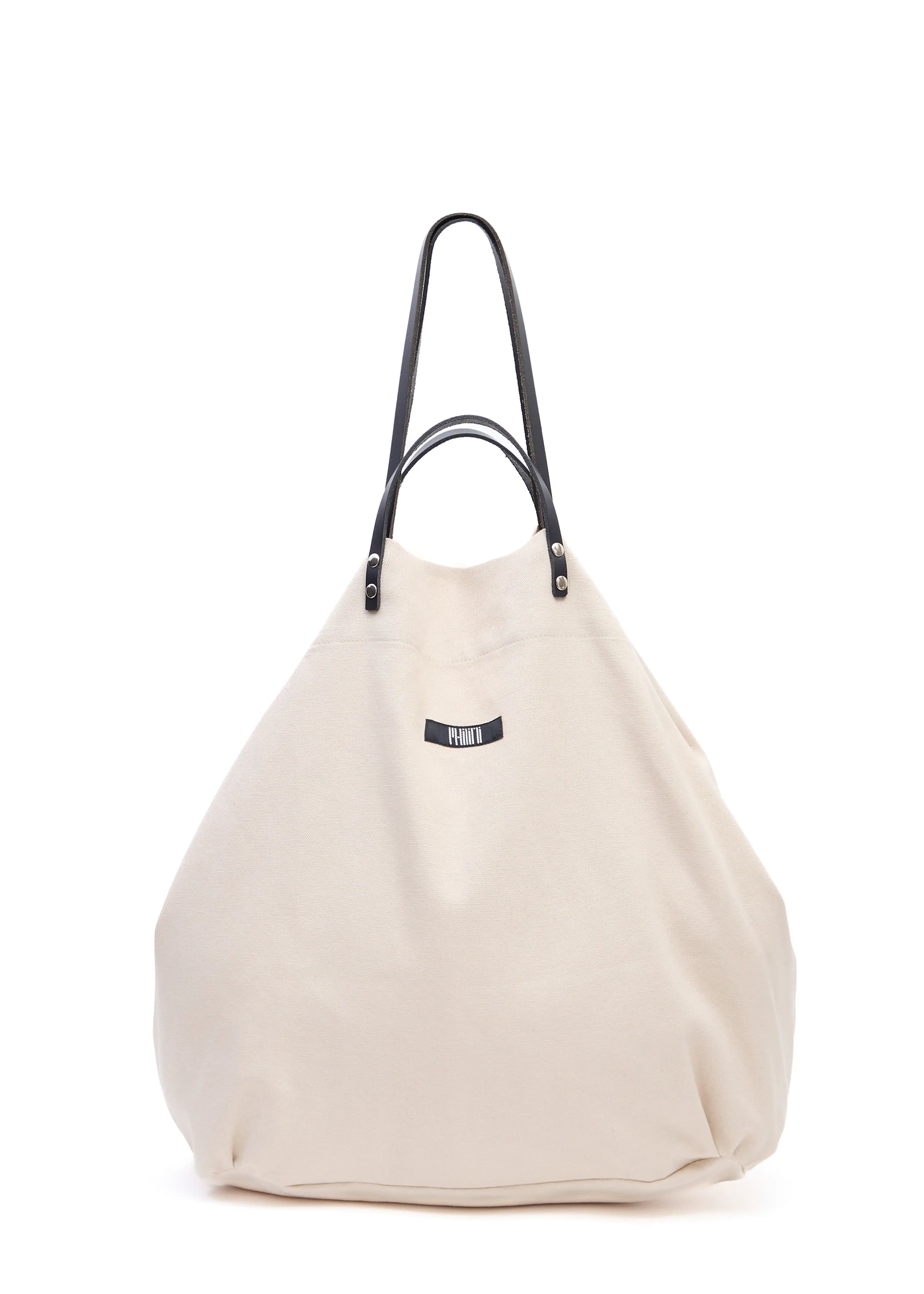 Front view of the Philini Shopper in soft cream cotton, featuring short and long calf leather handle