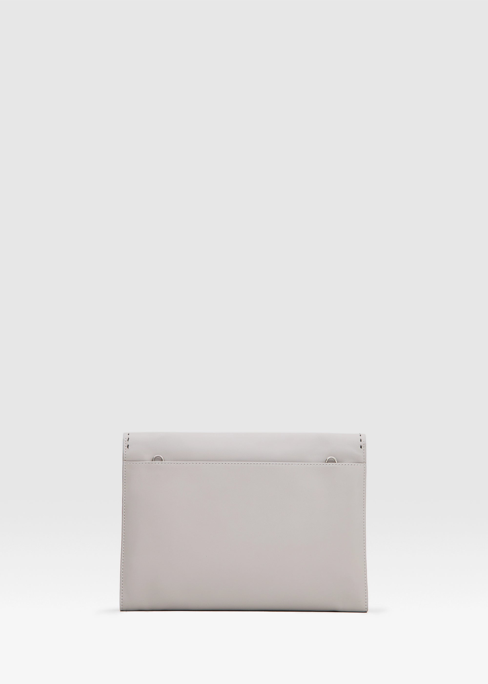 Back view of the Philini Valery Business Clutch in taupe aniline nappa leather, slim rectangular silhouette with large open back pocket and discreet silver hardware for strap. The handcrafted leather accessory for work essentials and professional style.