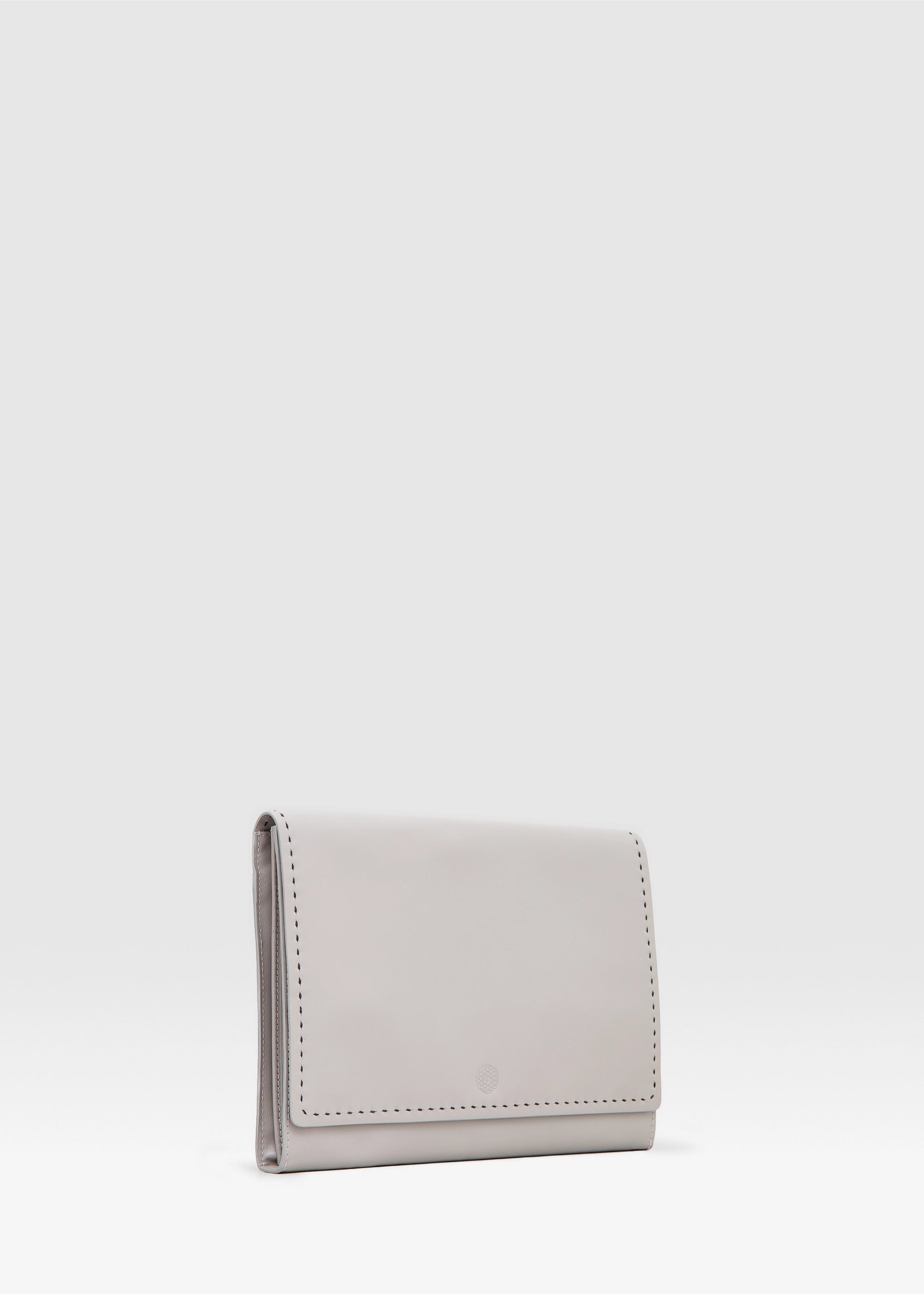 Side view of the Philini Valery Business Clutch in taupe aniline nappa leather, slim rectangular silhouette with large open back pocket and discreet silver hardware for strap. The handcrafted leather accessory for work essentials and professional style.