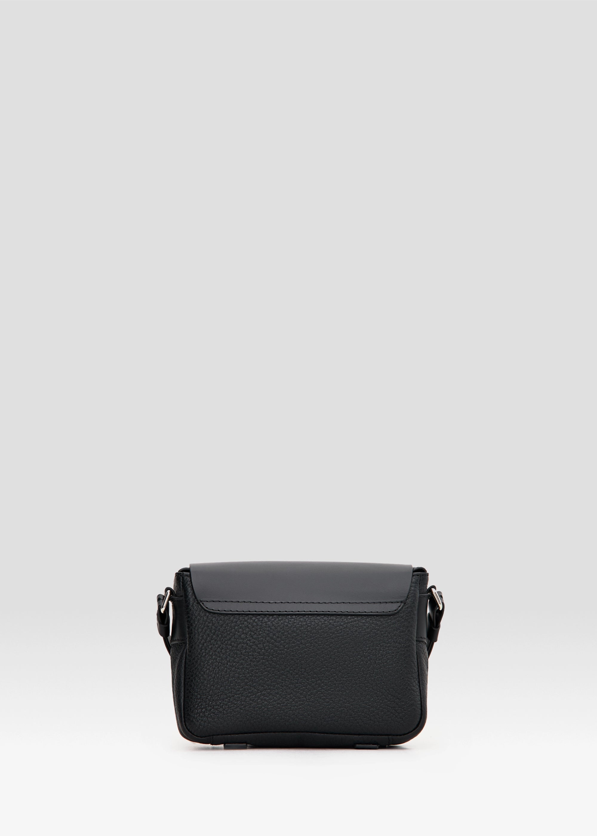 Back view of the Philini Whitney Black Leather Bag, featuring a buffalo leather back, adjustable leather strap with silver details, and a sleek rectangular design. A sustainable handmade designer bag crafted from premium materials in Germany