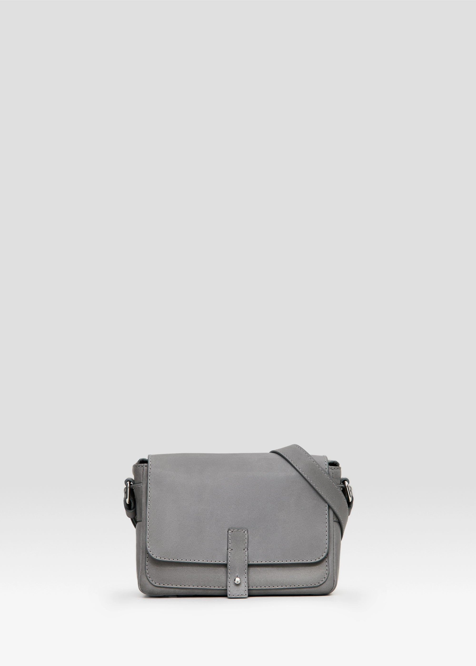 Front view of the Philini Whitney Grey Mini Crossbody Bag in nappa leather with adjustable strap and silver cufflink closure