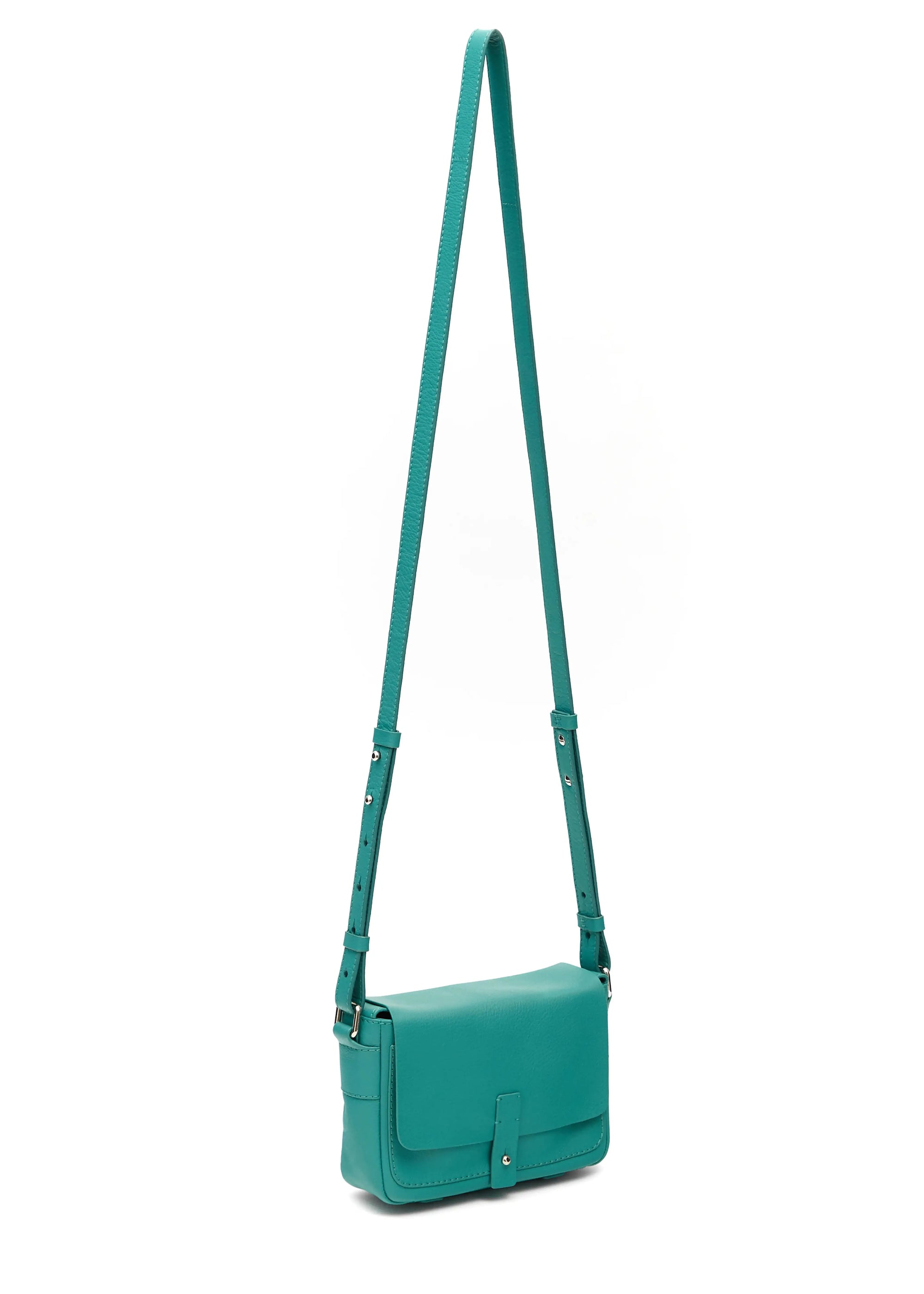 Side view of the Philini Whitney Mini Crossbody Bag in turquoise nappa leather, featuring a vertical rectangular shape, silver cufflink flap closure, and adjustable leather strap with silver hardware. A handcrafted mini designer handbag for everyday luxury and sustainable style.
