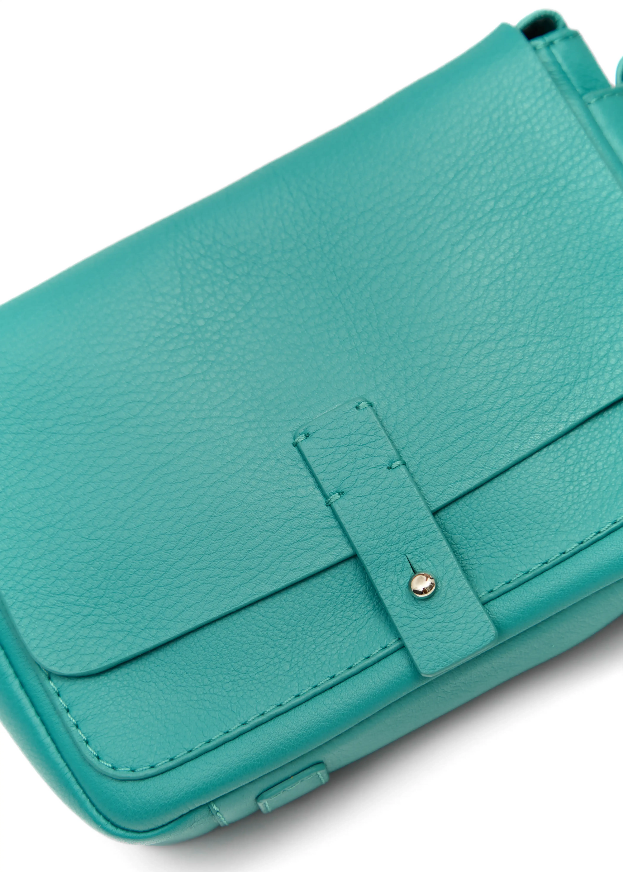 Close-up front view of the Philini Whitney Mini Crossbody Bag in turquoise nappa leather, featuring a vertical rectangular shape, silver cufflink closure, adjustable leather strap, and leather bottom pads. A high-quality  mini crossbody for everyday elegant and sustainable style