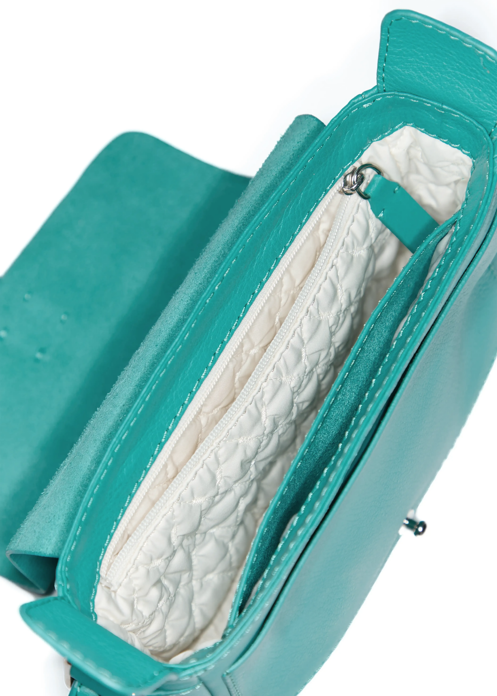 Inside view of the Philini Whitney Mini Crossbody Bag in turquoise nappa leather, showing main compartment, zippered pocket, leather phone pocket, and fabric lining. A compact, handcrafted luxury crossbody for everyday essentials and conscious fashion.