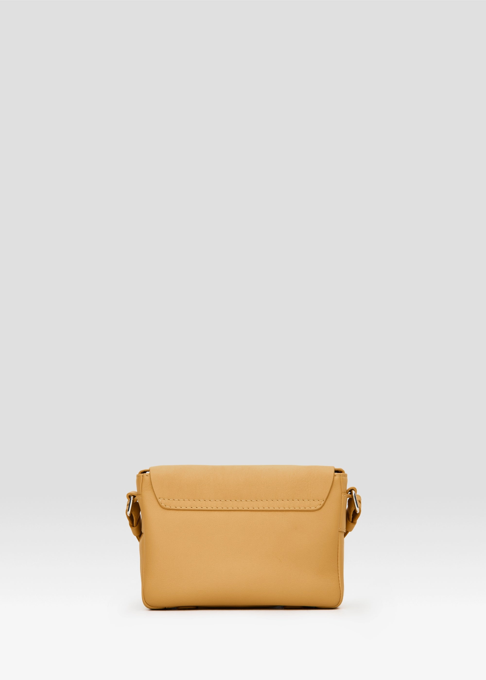 Back view of the Philini Whitney Mini Crossbody Bag in yellow nappa leather, featuring a vertical rectangle silhouette, adjustable leather strap with silver hardware attachment. A shoulder bag made of natural leather