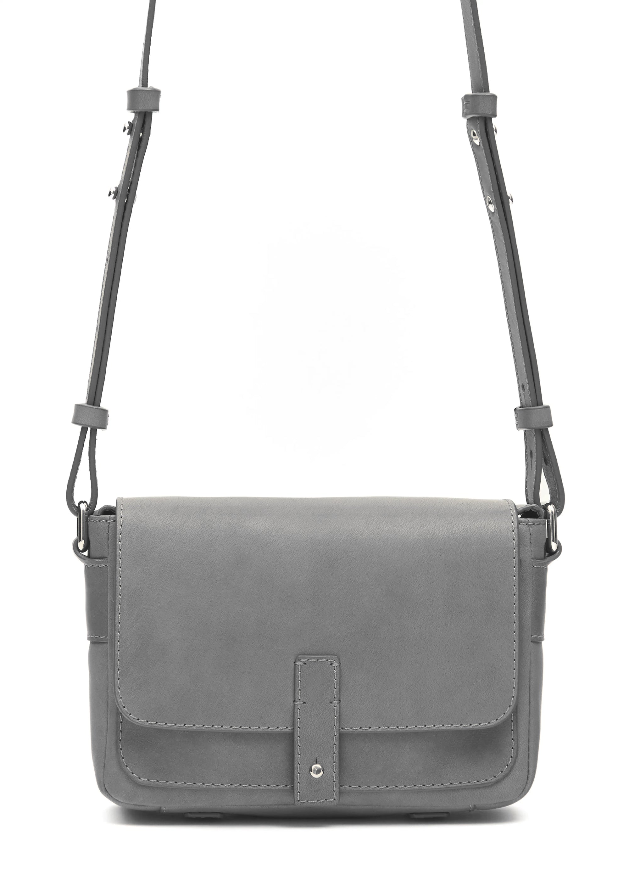 Close front view of the grey Philini Whitney Mini Crossbody Bag in nappa leather, showing hand-stitched details, silver cufflink closure, and adjustable strap. A compact handmade leather bag.